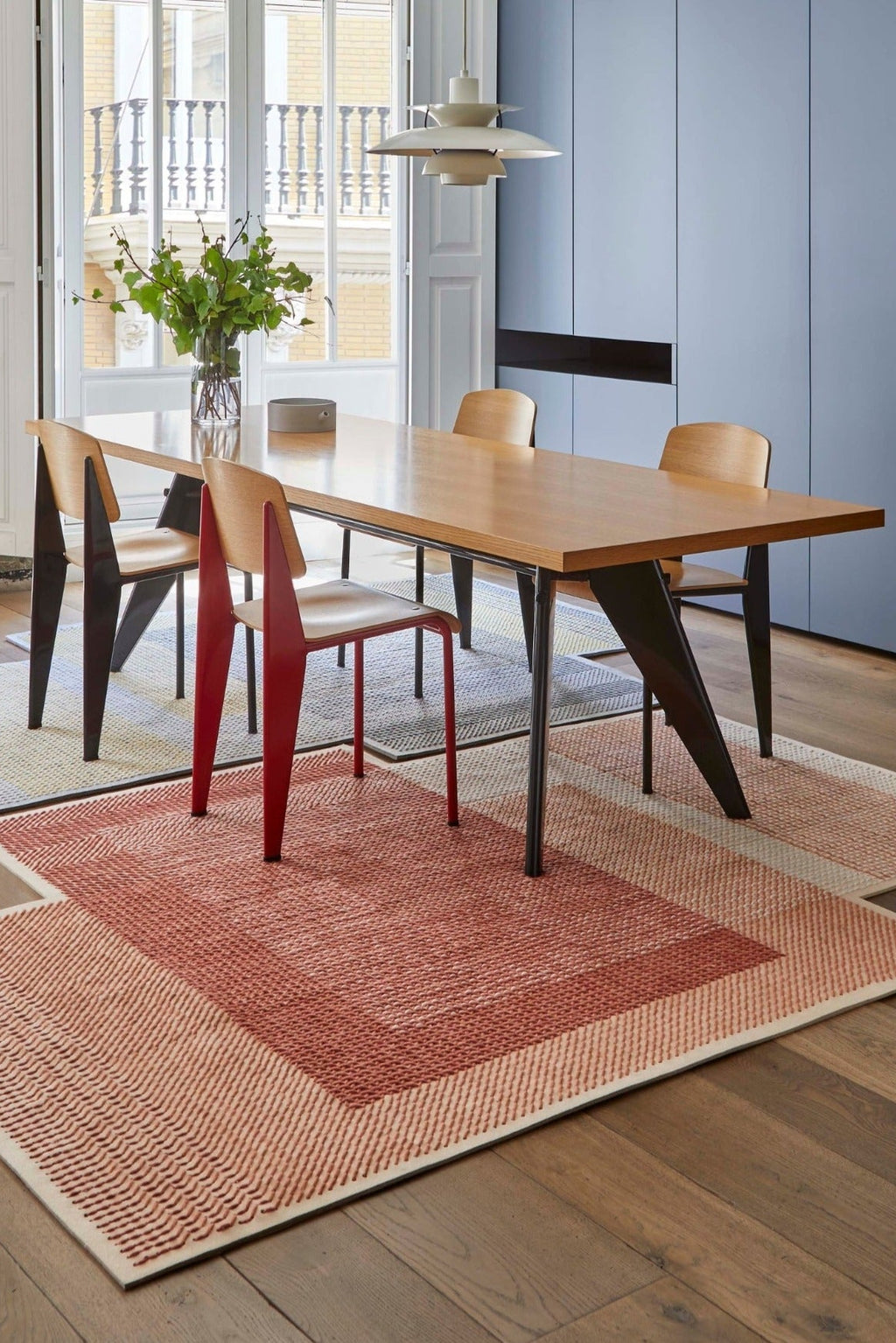 GAN Rugs Canevas Geo Rug, a striking hand-embroidered wool area rug featuring a richly textured, geometric pattern in warm terracotta, peach, and cream tones. This modern contemporary design adds depth and visual interest, perfect for a stylish dining room or inviting living room space.